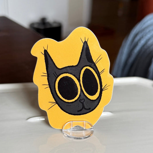 Yellow background with yellow big eyed black cat 